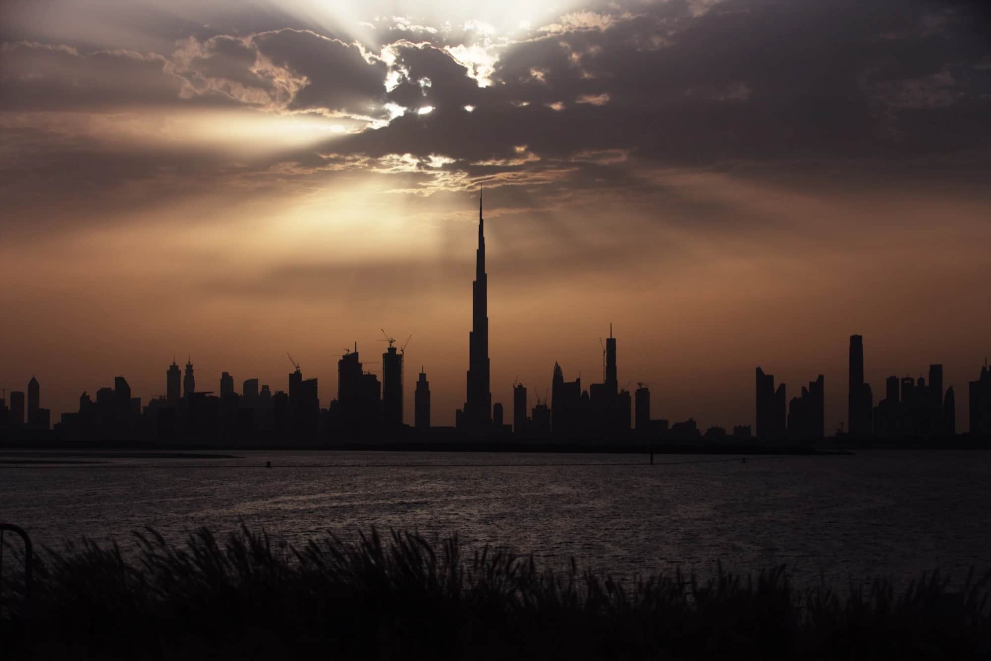 The Burj Khalifa silhouetted against the Dubai skyline at sunset