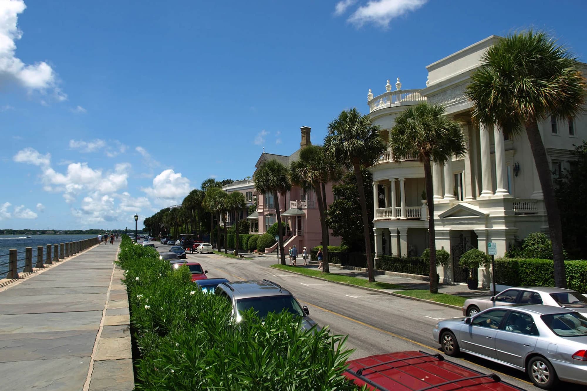 Historic pastel row houses along East Battery Street on the Charleston Battery, South Carolina, with the harbor in view