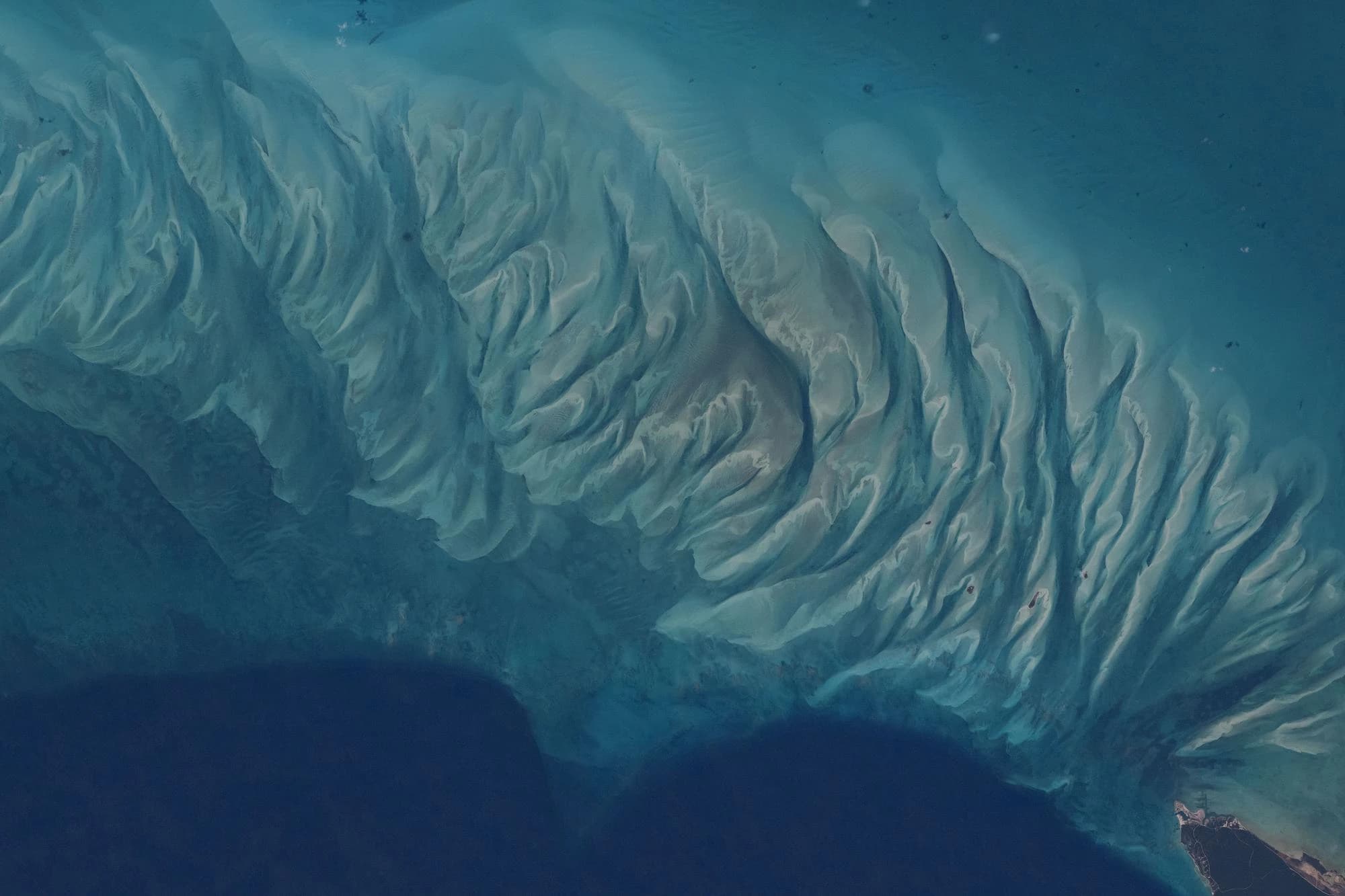 Aerial NASA astronaut photograph of the swirling turquoise sandbars and tidal patterns off the coast of Eleuthera, Bahamas