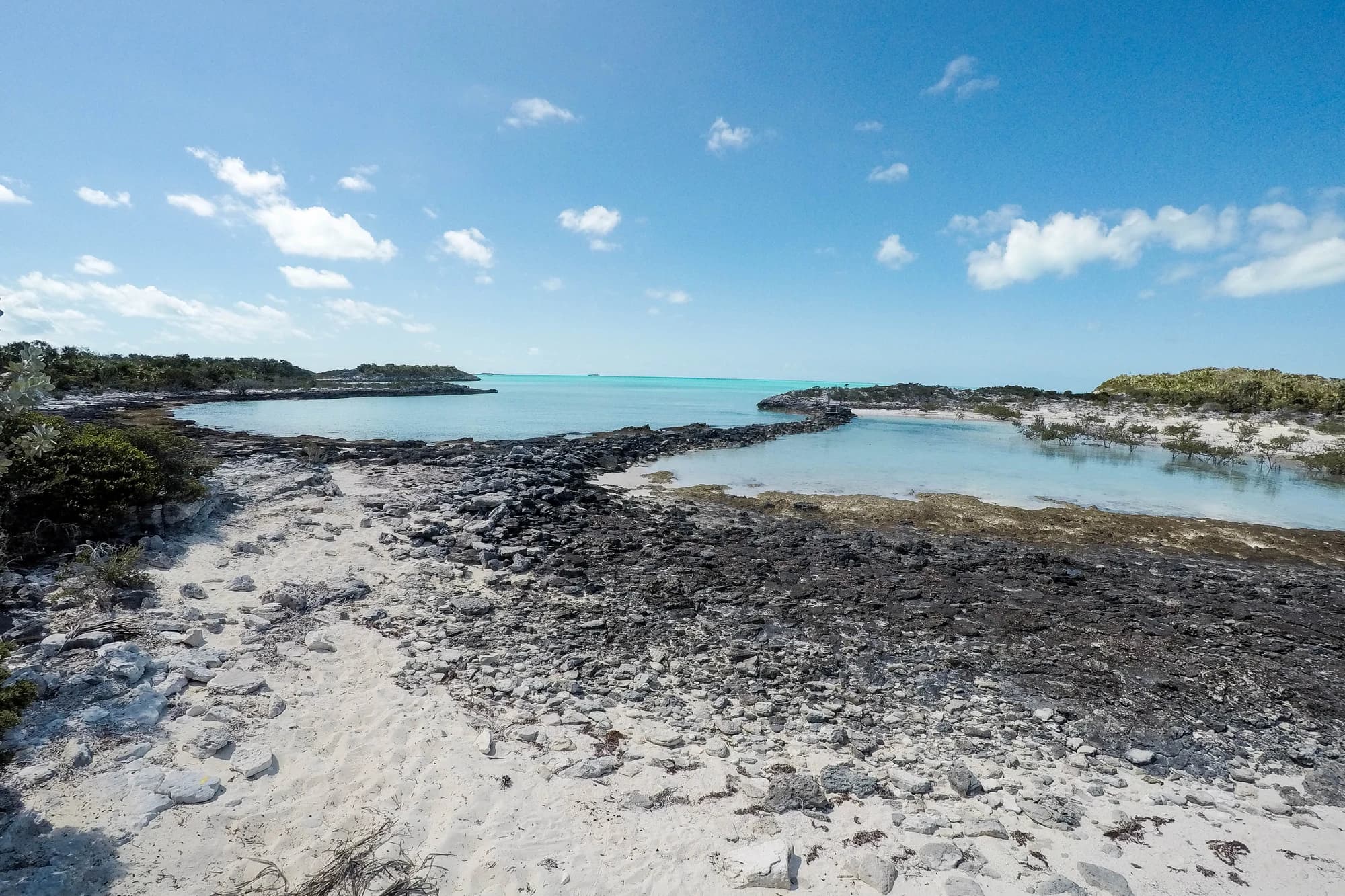 Turquoise cove and rocky limestone shoreline in the Exuma Cays Land and Sea Park, Bahamas