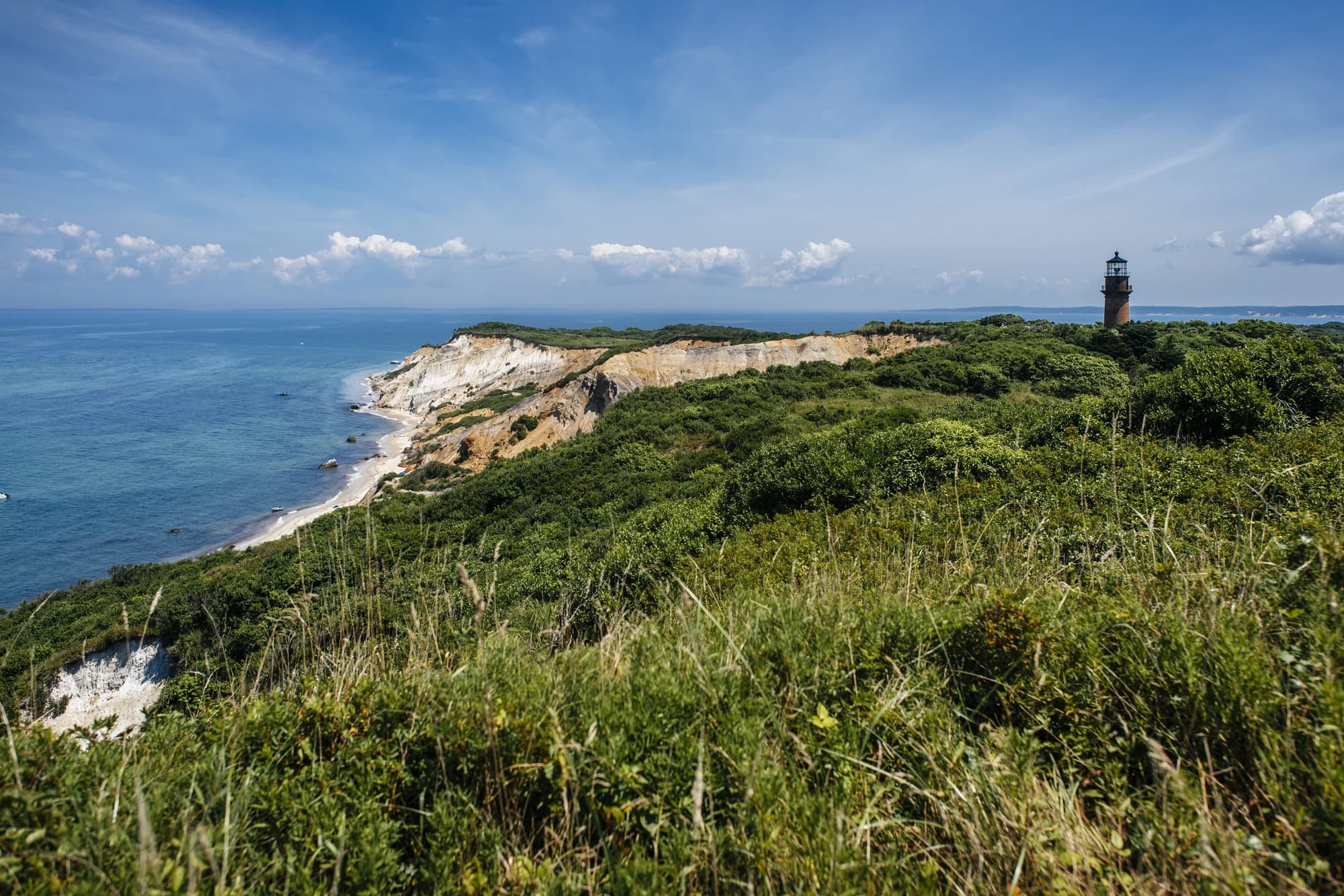 Aerial view of the Aquinnah Cliffs and Gay Head Lighthouse on Martha's Vineyard, Massachusetts, on a summer day