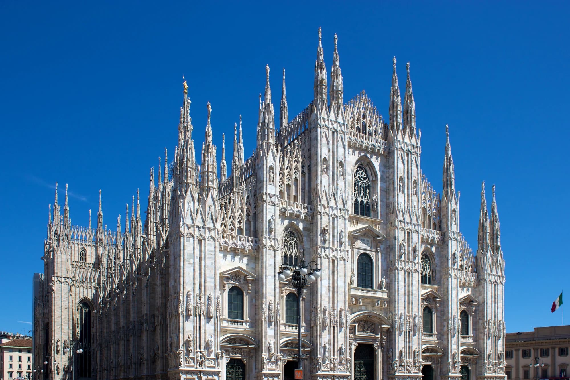 The Gothic facade and spires of Milan Cathedral (Duomo di Milano) from Piazza del Duomo