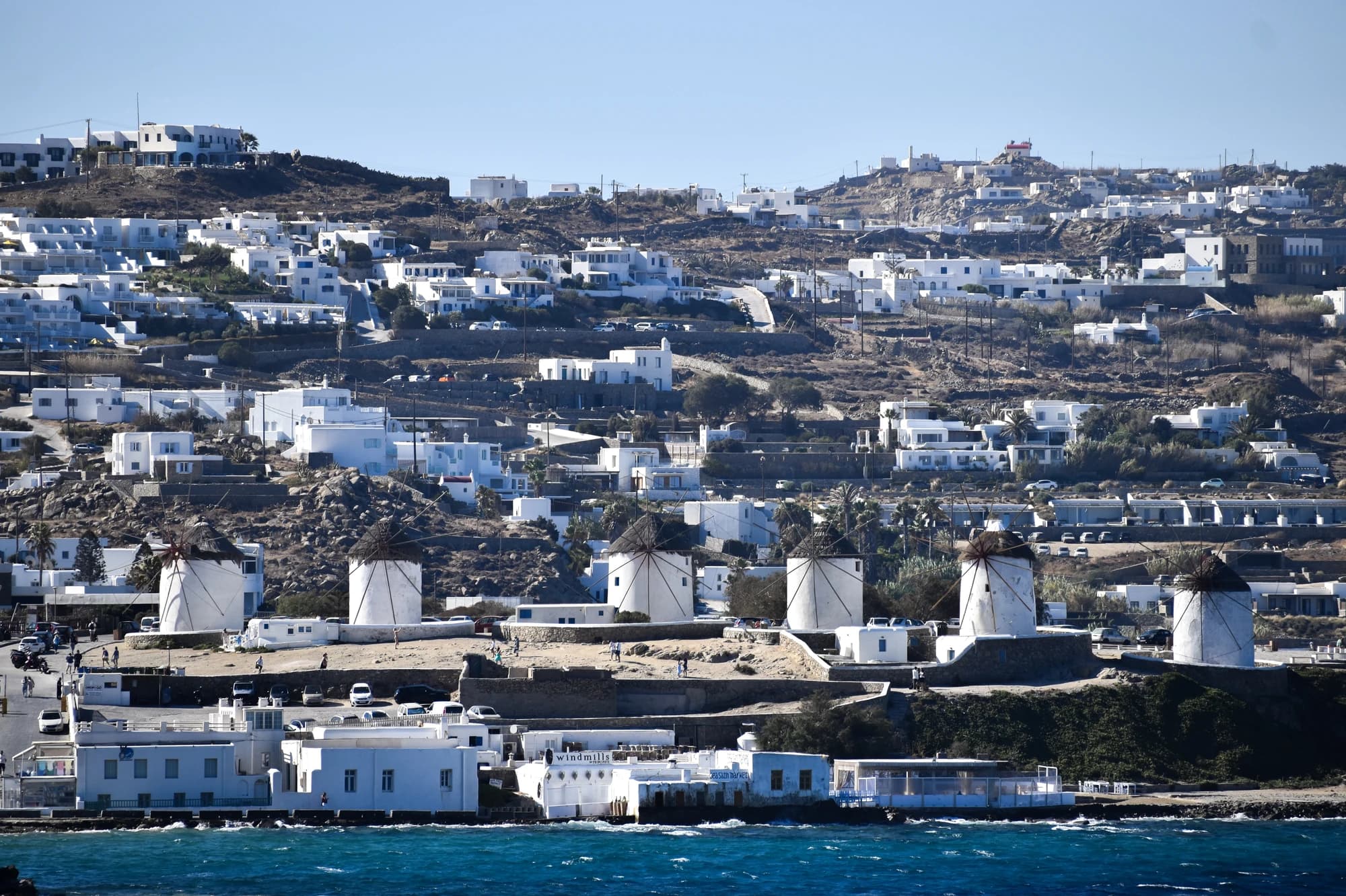 The iconic whitewashed windmills of Mykonos overlooking the Aegean Sea