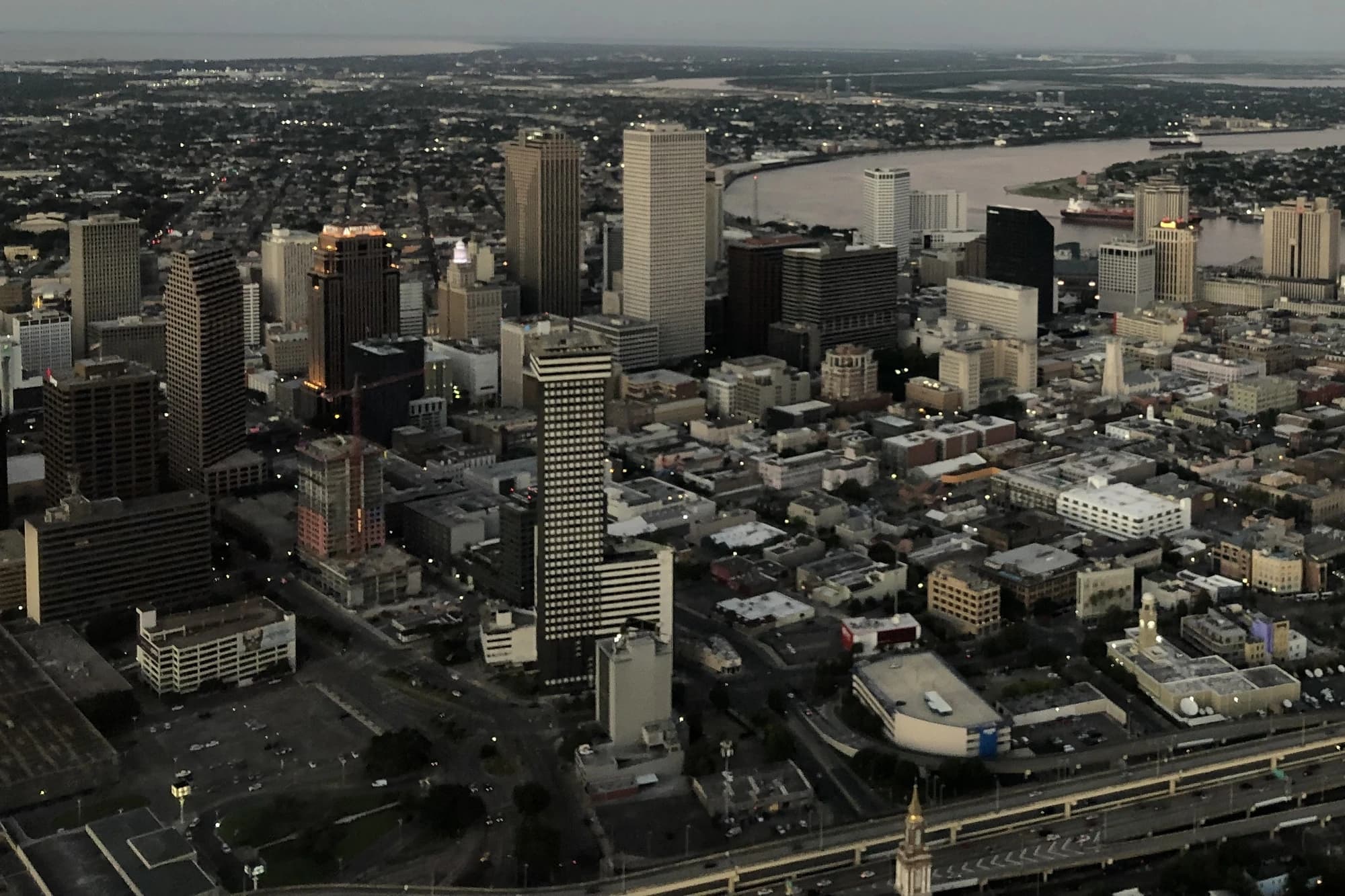 Aerial dusk view of downtown New Orleans's Central Business District skyline alongside the Mississippi River