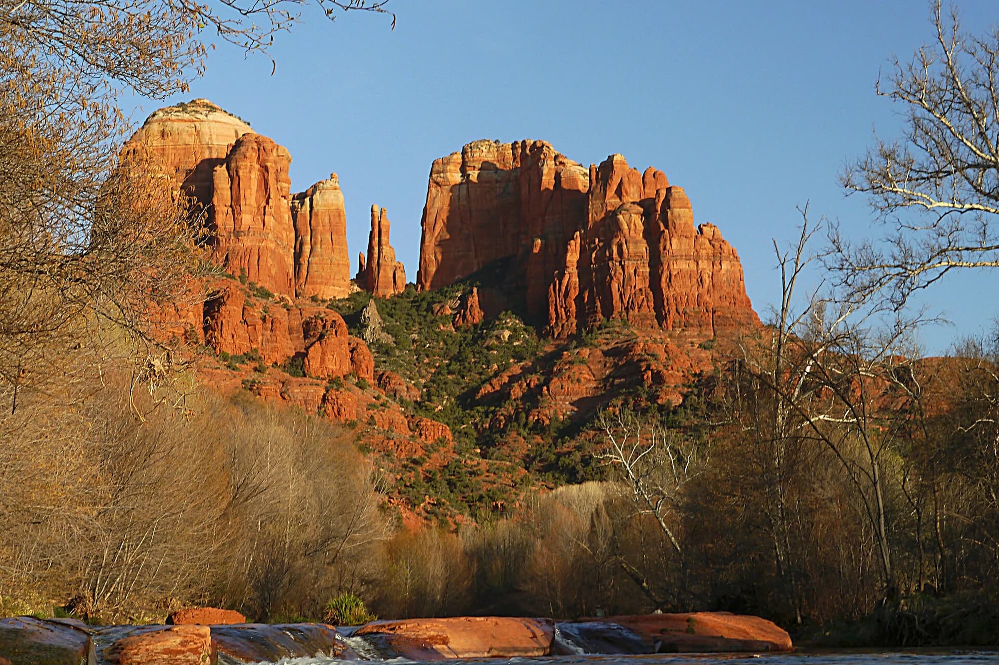 Cathedral Rock rising above Oak Creek near Sedona, Arizona, with the red rock formation reflected in the water