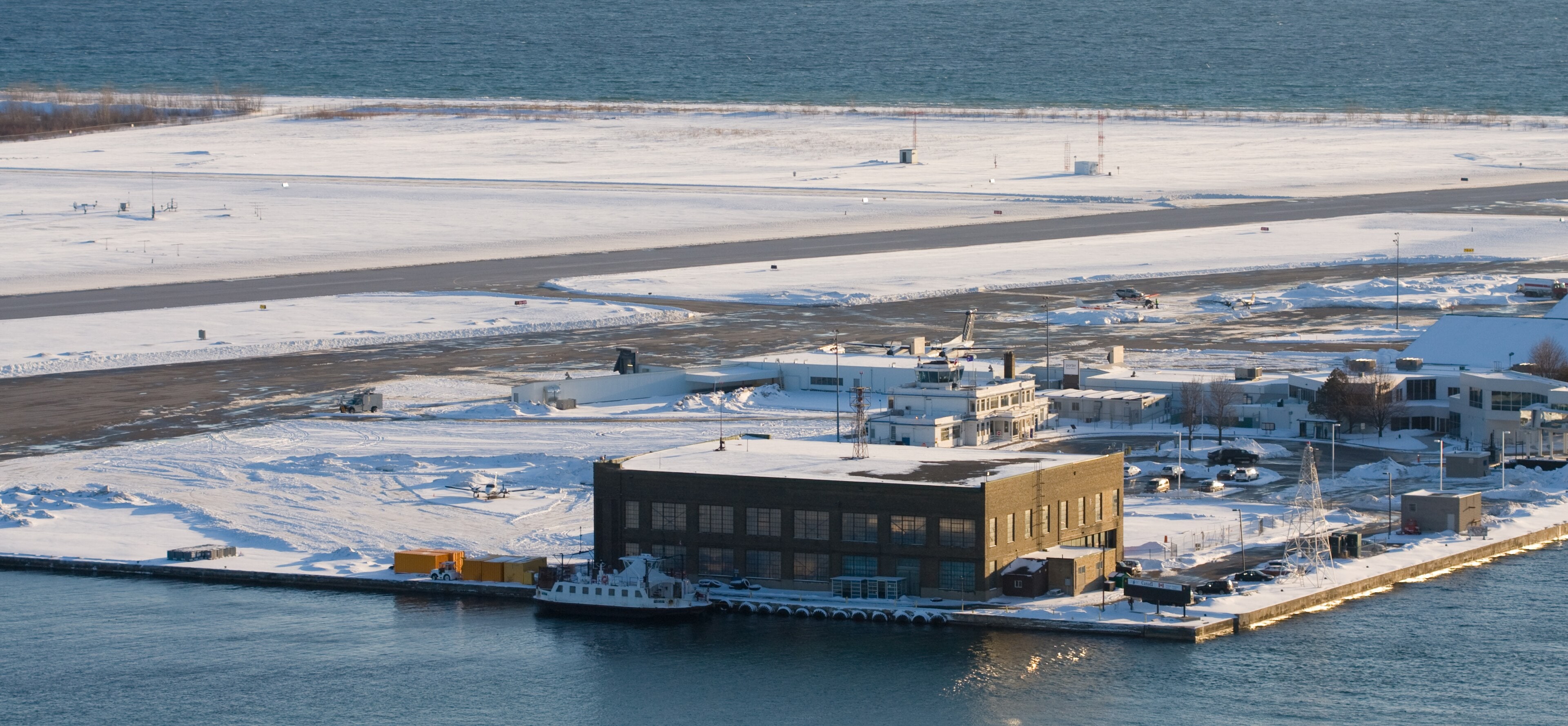 Aerial view of Billy Bishop Toronto City Airport on the Toronto Islands with the downtown skyline behind it