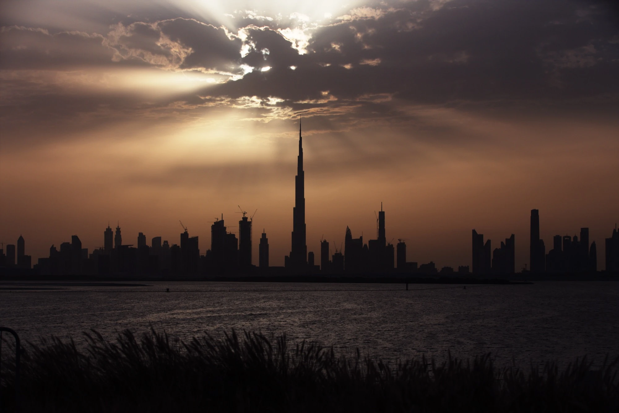 The Burj Khalifa silhouetted against the Dubai skyline at sunset