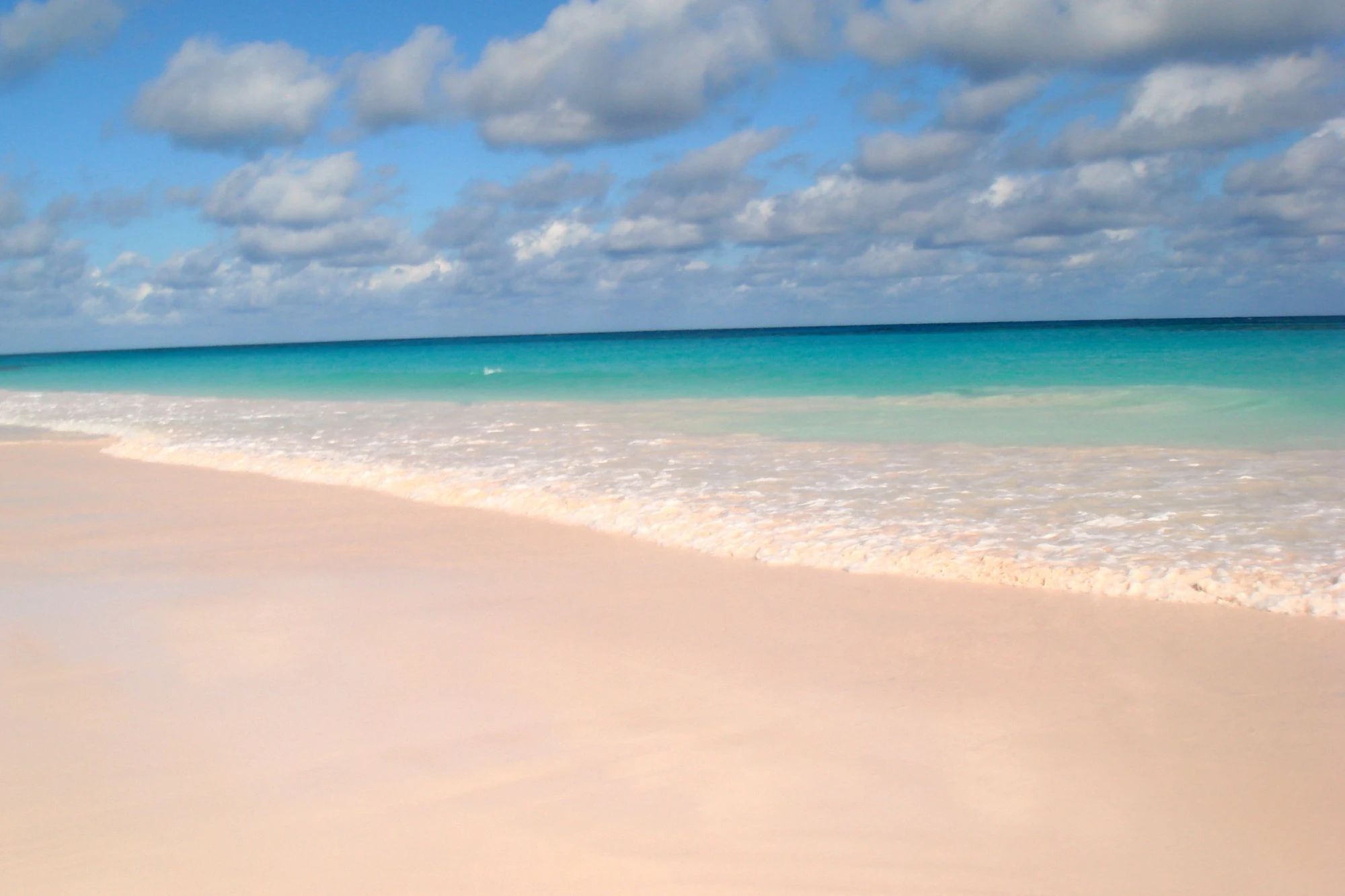 Harbour Island's famous pink sand beach meeting turquoise Bahamian waters