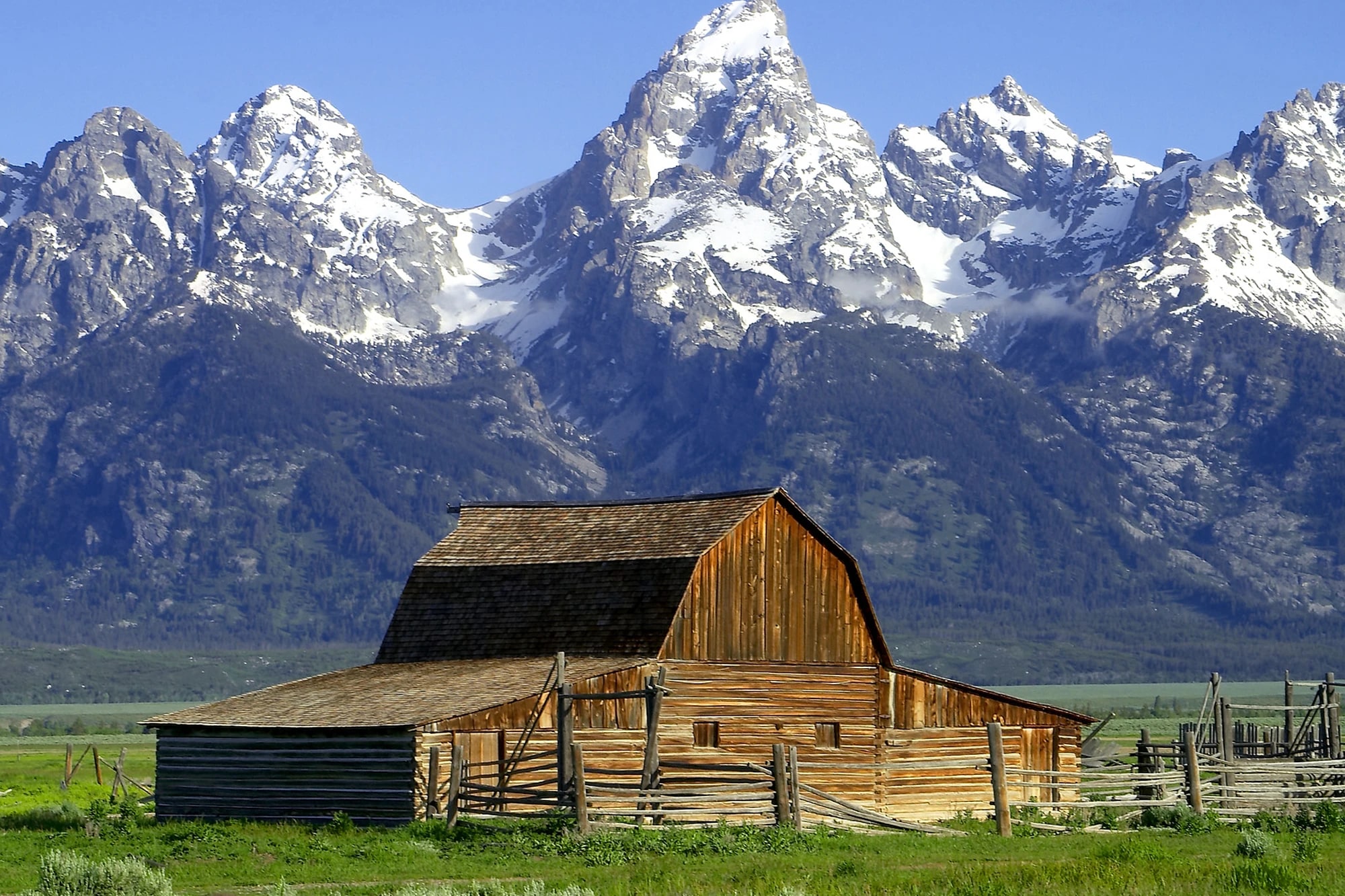 Historic T.A. Moulton Barn on Mormon Row with the Grand Teton mountains rising behind it, Wyoming