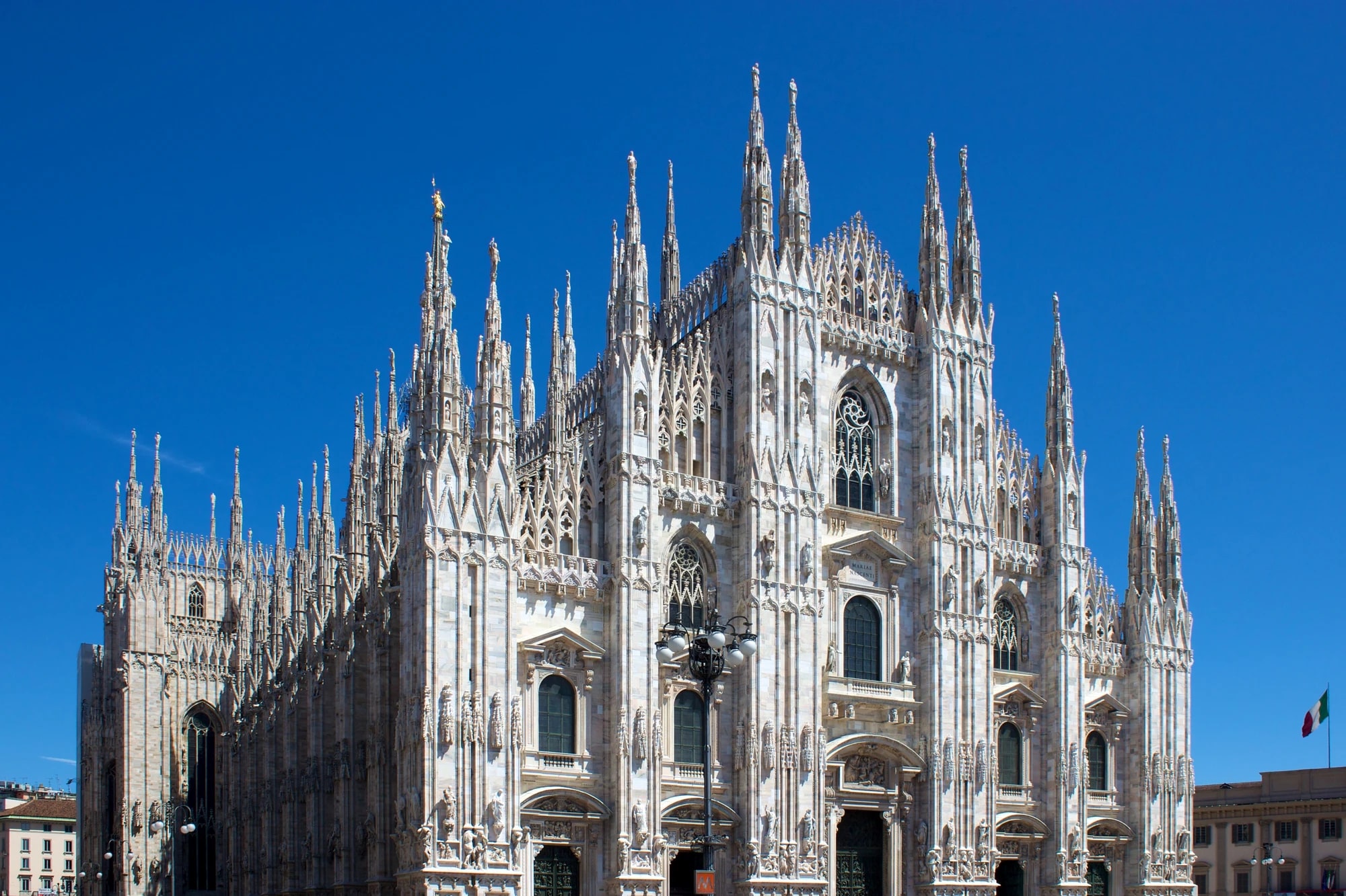 The Gothic facade and spires of Milan Cathedral (Duomo di Milano) from Piazza del Duomo