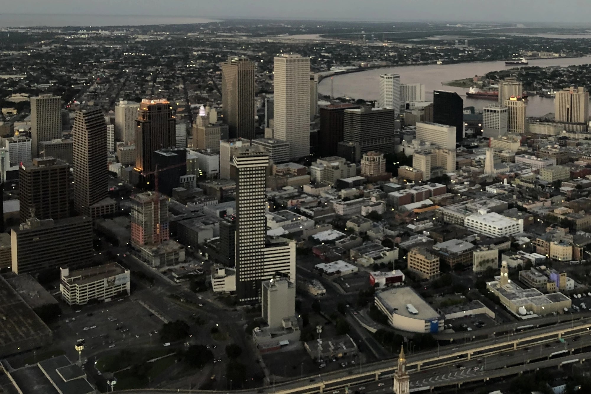 Aerial dusk view of downtown New Orleans's Central Business District skyline alongside the Mississippi River