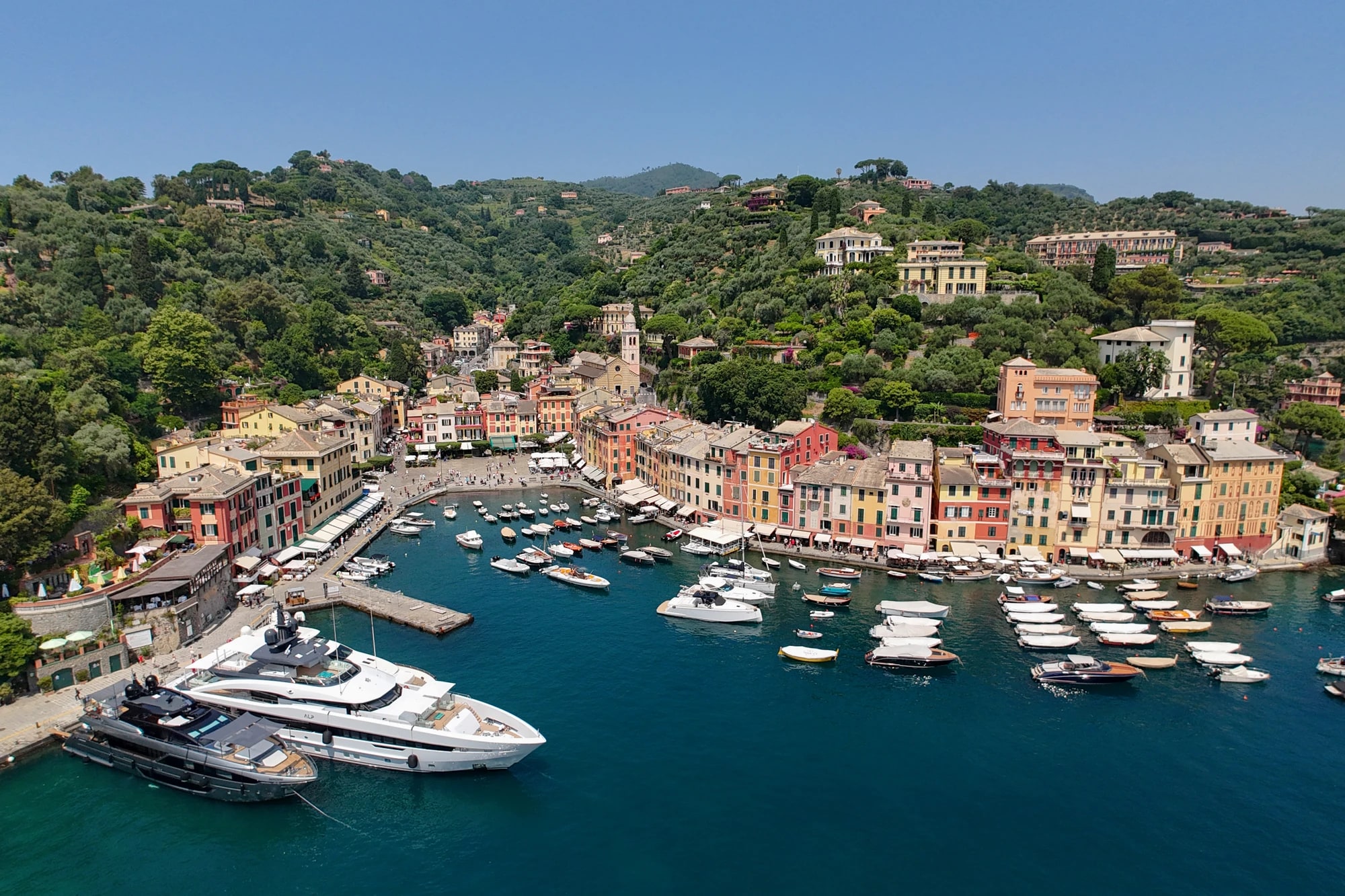 Aerial view of Portofino's pastel harbor houses and yachts on the Italian Riviera